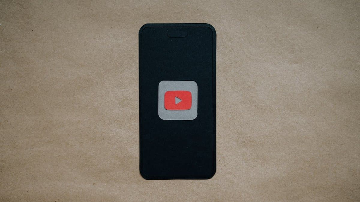 Viewer watching YouTube Shorts on smartphone with auto-generated captions displayed on screen in vertical video format — Photo by Kelly Sikkema on Unsplash