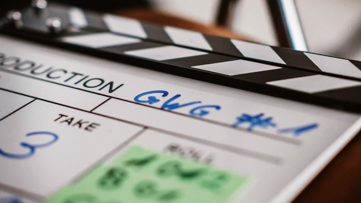 Writer and filmmaker reviewing B-roll shot list with script notes for strategic short-form video planning — Photo by Leuchtturm Entertainment on Unsplash
