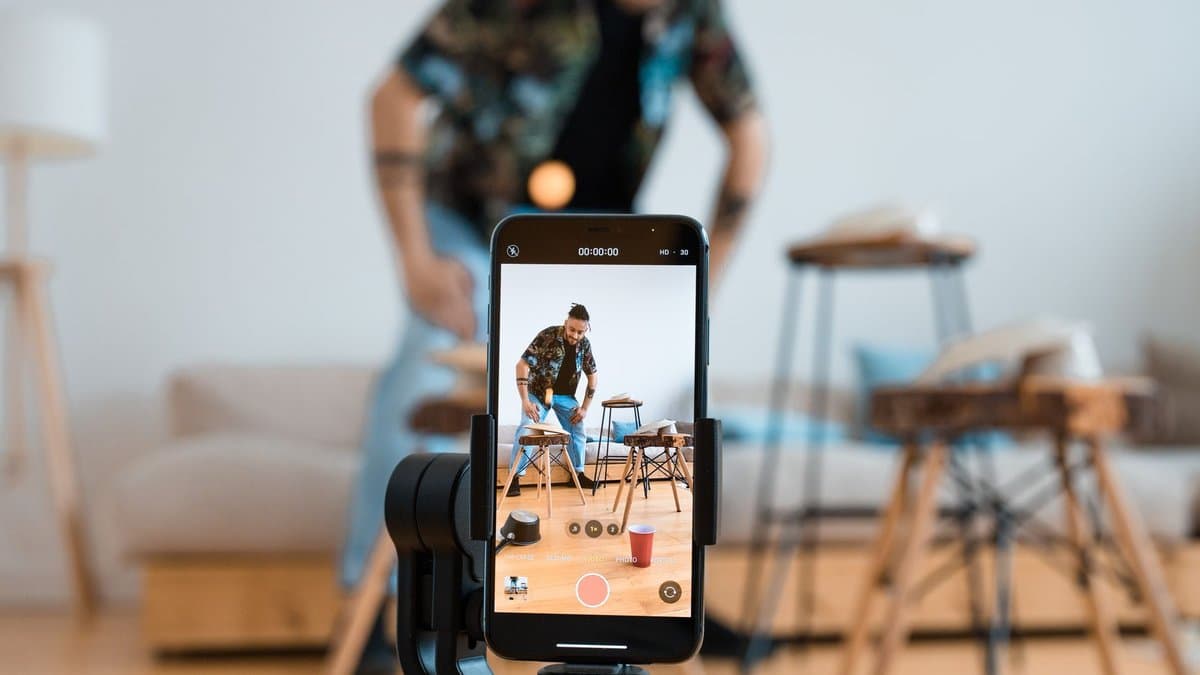 Mobile phone screen showing a vertical stream clip with prominent word-level captions burned into the bottom third — Photo by Ron Lach on Pexels