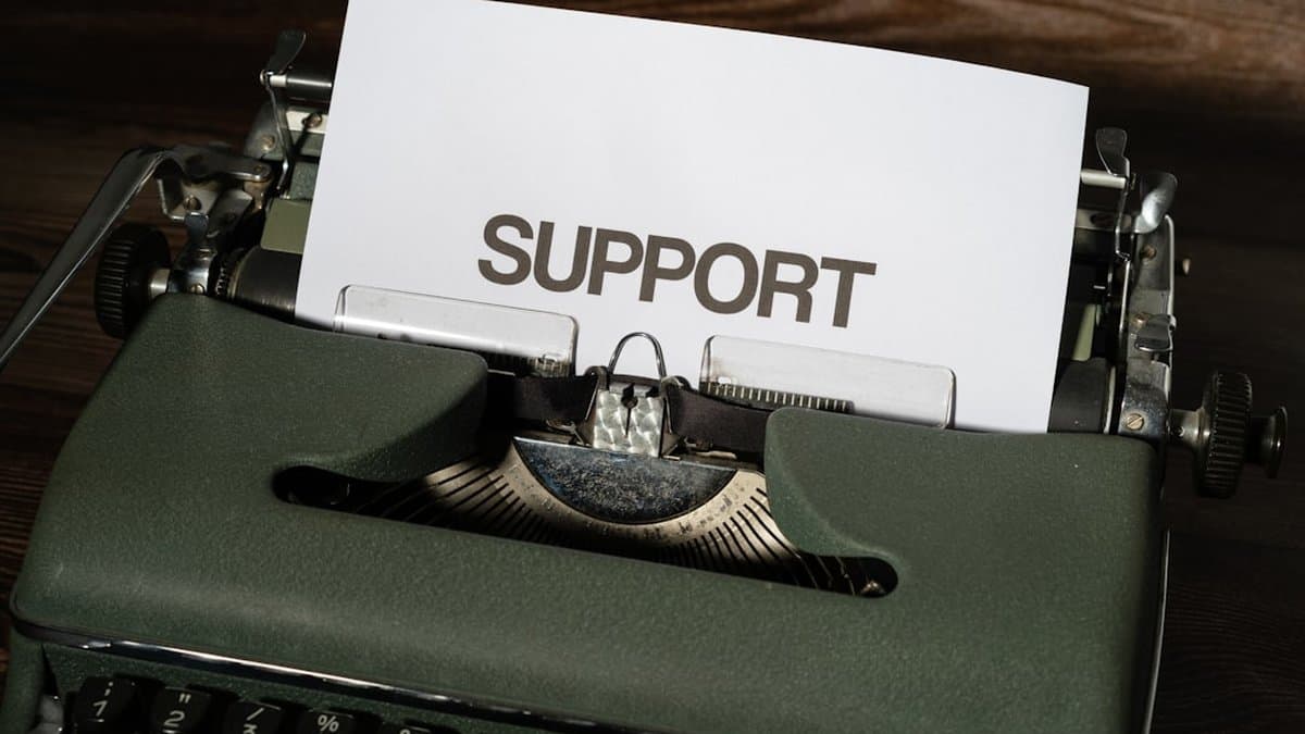 Professional customer support portal with comprehensive documentation, video tutorials, and live help resources — Photo by Markus Winkler on Unsplash