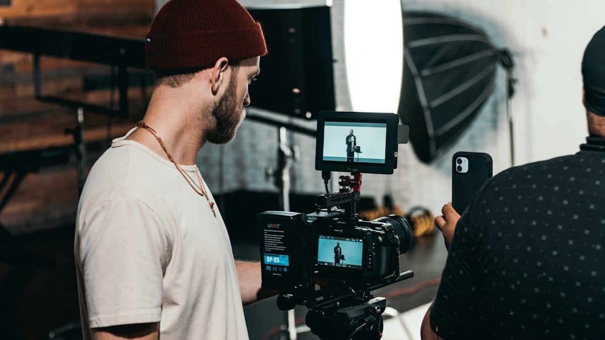 Content creator reviewing and editing TikTok video on smartphone to improve hook quality and optimize early engagement signals — Photo by Kyle Loftus on Unsplash