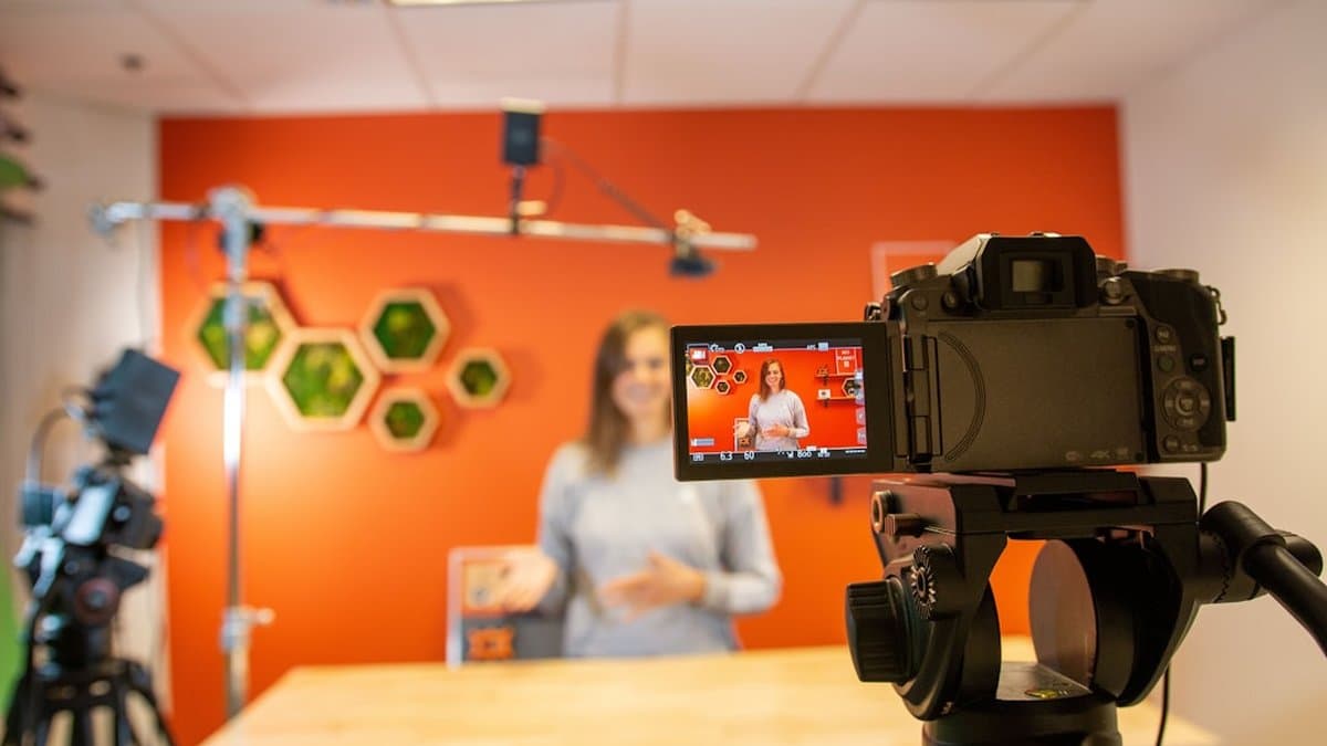 Volunteer recording a nonprofit impact story on smartphone camera with genuine emotion and authentic setting — Photo by Kelly Huang on Unsplash