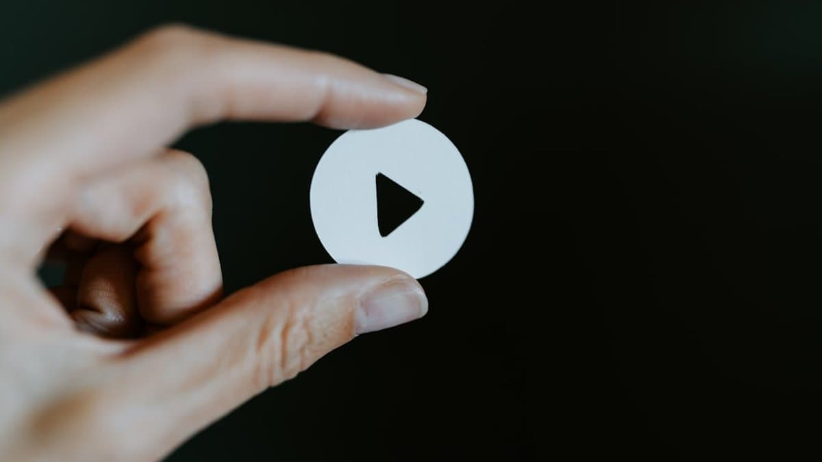 Mobile phone showing short-form video with prominent on-screen text hook visible before any audio plays. — Photo by Kelly Sikkema on Unsplash