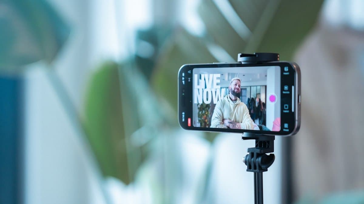 Financial advisor filming short-form video content on smartphone for TikTok and Instagram Reels distribution — Photo by Detail .co on Unsplash